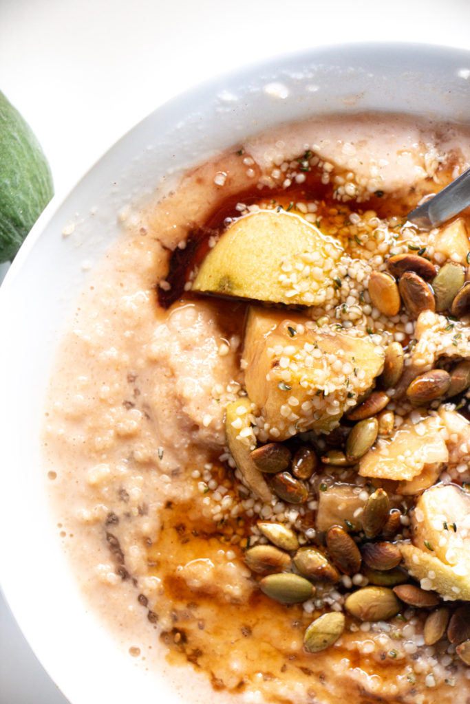 Millet and feijoa porridge with maple syrup, hemp seeds and pumpkin seeds.